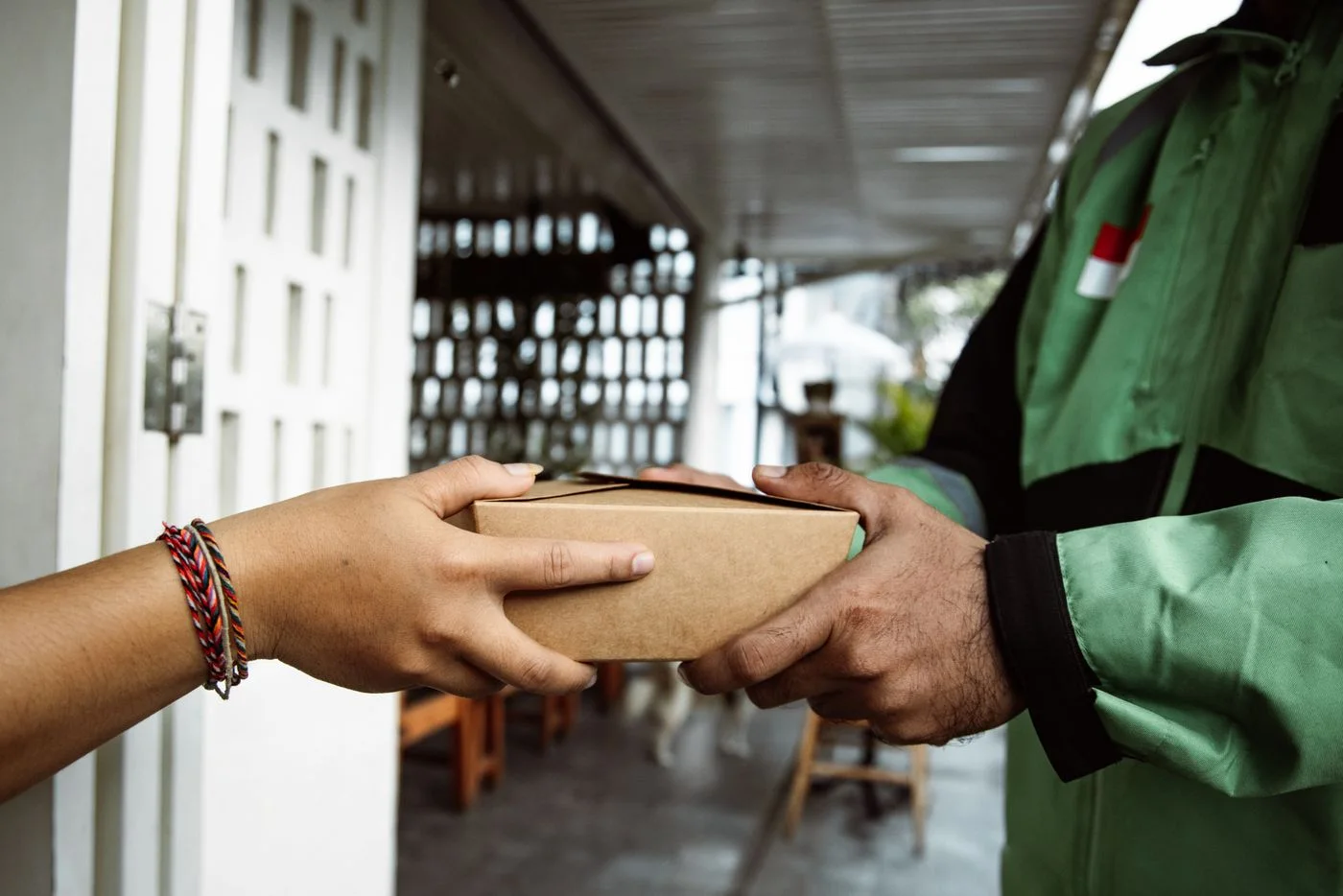A small parcel being handed to its recipient.