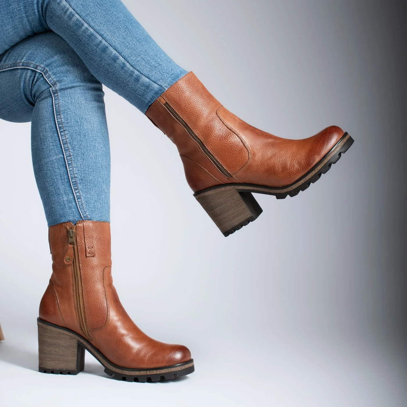 Brown ankle boots worn with fitted jeans.
